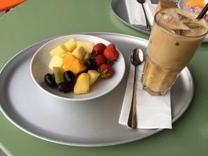 bowl of fruits and iced soya lattte (sugarfree) at Tibits - Gundeli in Basel