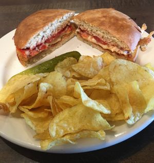 Yum. Vegan Mock Chicken Parmigiana. Toasted breaded vegan mock chicken, classic red sauce, topped with onions, tomato & vegan cheese. at Pizza Luce in Eden Prairie