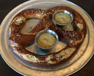 Bavarian Pretzel appetizer. Served warm with spicy whole grain mustard. Super soft with just the right amount of salt. Yum. at Pizza Luce in Eden Prairie
