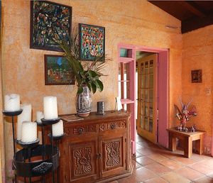 I hope you like bright colors! Entrance is filled with a mish mash of Oaxacan colors, figurines, South African art, Moroccan plates, Spanish details at Loft on a Lake in Brownsville