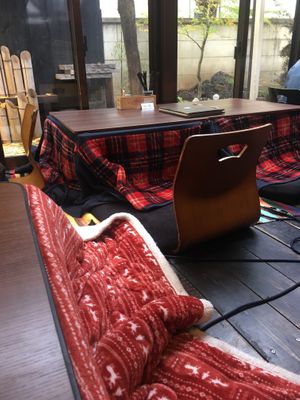 December. The kotatsu is a Japanese table with a built-in heater and a blanket that covers all four  at Farmer's Cafe Project in Tokyo
