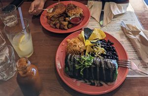Near side: mole burrito. Far side: Reuben melt with potato side. Also my homemade hot sauce and fantastic pineapple ginger lemonade at The Grain Cafe in Redondo Beach