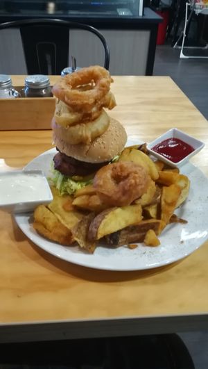 The Barley Burger, served with chunky chips, onion rings, tomato sauce, and house blend aoili.  at Barley in Palmerston North