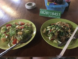 Vegan glass noodle salad w added tofu + vegan pad kee mao (flat noodle with chili and holy basil). GOOD!! and the wifi password 😅 at Nok's Kitchen in Koh Phangan