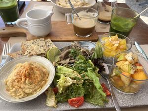 Vegan breakfast, hummus, juice, coffee, fruit, mushrooms & chia seed pudding  at Tazza in Giro in Lisbon