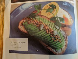 Menu page showing avocado toast plus egg at Latte Graphic in Tokyo