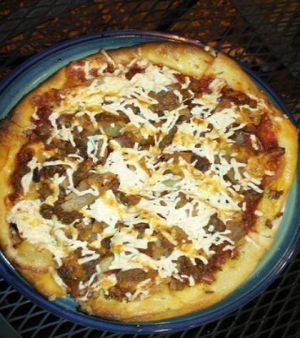 Vegan Surprise Pizza with seitan pepperoni, tempeh bacon, seasoned tofu, pineapple, onion, green pepper with chipotle mayo drizzled on top. at Brick Road Pizza Co in Grand Rapids
