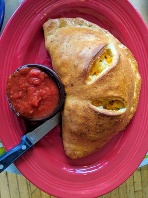 Vegan mac and cheese calzone with tempeh bacon and italian sausage at Brick Road Pizza Co in Grand Rapids