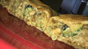 Vegan Mac n Cheese Calzone with black olives, vegan bacon, and broccoli at Brick Road Pizza Co in Grand Rapids