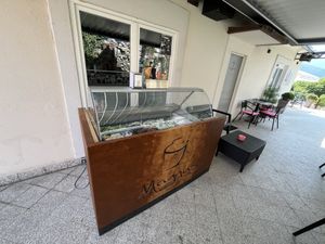 ice cream chest freezer in front of the entrance  at Kavarna Sladoledarna Magnus in Nazarje