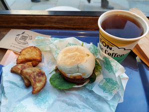 Hash browns (interesting twist with the parsnip), 'Vegan Sausage Muffin'  with spinach, and coffee at LEON - Strand in London