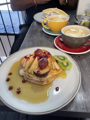 Vegan pancakes with maple syrup and fresh fruit and oat cappuccino’a  at Budapest Baristas in Budapest