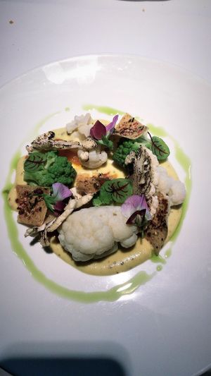 A cauliflower curry with on top all kinds of cauliflower prepared in different ways. Served with quinoa crunch.  at TOV in Schagen