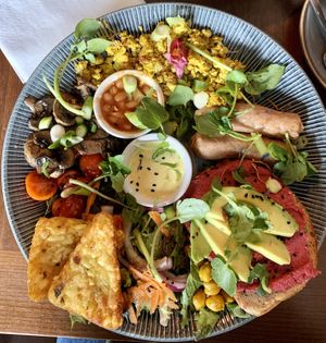 Scrambled Tofu Full Breakfast: with vegan sausage, tamari mushrooms, beans, tomatoes, spiced chickpeas, beetroot hummus and avocado hummus, hash browns and salad leaves    at Bio Cafe in Aberdeen