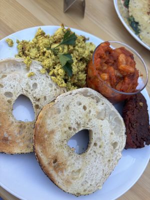 Bagel, scrambled tofu, beans and sausage (beetroot)   at Tierra in Tenerife