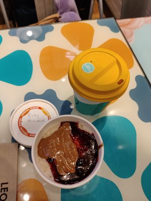 Ruby almond porridge with "activated" almond milk and soya latte at STN - LEON in Stansted