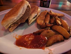 Partially eaten (sorry) vegan Cubano with wedge fries at The Church Cantina in Tacoma