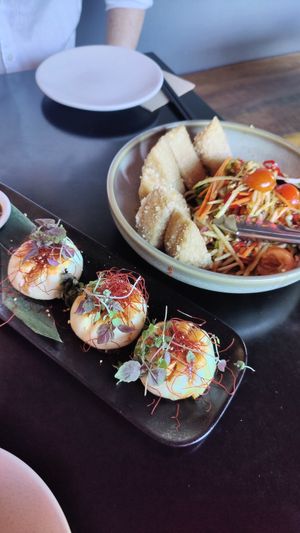 Top rights: crispy tofu with papaya salad, bottom left: Pan-fried shiitake mushroom BBQ buns at Yulli's in Byron Bay