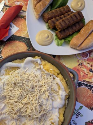 Mici (sausages) and Mâmâligâ (polenta, sour cream and cheese) - sounds interesting but I really liked it! at Level Up in Bucharest