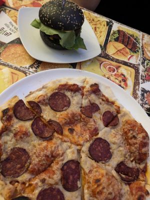 Salami pizza and a burger. at Level Up in Bucharest