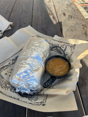 Burrito with side of green chili which  at Illegal Pete's - Northside in Denver