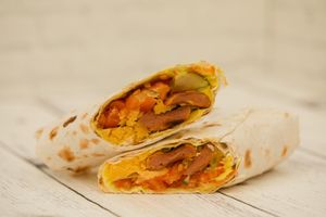 Carbonara - Wheat sausage, vegan cheese, cheese sauce, tomatoes, pickles, pita at Vega in St Petersburg