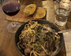 Pappardelle (spaghetti) funghi e tartufo, garlic bread (both asked to be made vegan) and Pinot noir.   at Maccaroni Trattoria Italiana in Melbourne