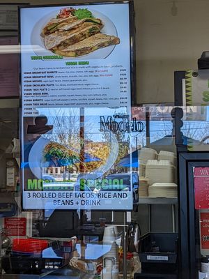 Dedicated vegan menu monitor right behind the counter, and a big Happy Cow sticker at Cruz Tacos in Murrieta