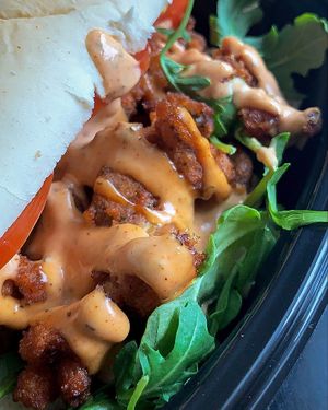 Close up of the Rich Boi - breaded oyster mushrooms and remoulade, with arugula and tomato at Willowbeez Soulveg in Columbus