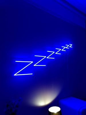 Neon signs up upper hall with fridge containing oat milk at Saorsa 1875 in Pitlochry