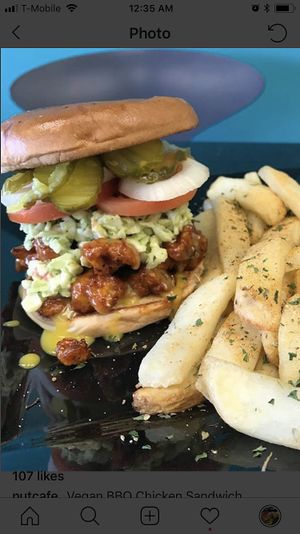 BBQ vegan chicken burger and a side of fresh baked steak cut potatoes. at Nut Cafe in Jonesboro