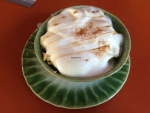 Hot breakfast- soaked grains with goji berries, Apple, banana, rice milk and vanilla custard at Tushita in Munich