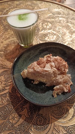 Smallest matcha in the world (5,8€) and a piece of a cake. at Tushita in Munich