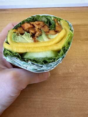 Spring sandwich in lettuce wrap. Lettuce, cucumber, avocado, sweet potato, mango, and mango sauce.   at Spring Cafe in New York City