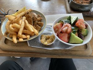 Vegan chicken bowl with a side of chips and vegan Greek salad and smokey eggplant dip.   at Zeus Street Greek in Canberra