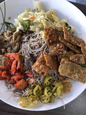 Fried bee hoon with side dishes at Taste of Vegetarian in East Singapore
