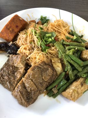 Fried mee Siam with side dishes include otah  at Taste of Vegetarian in East Singapore