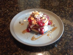 Banana pancakes with fruit compote, mixed seeds and agave at Nourish in Teignmouth