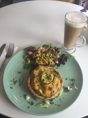 Cheesy broccoli and leek tart with salads and a latte  at Nourish in Teignmouth