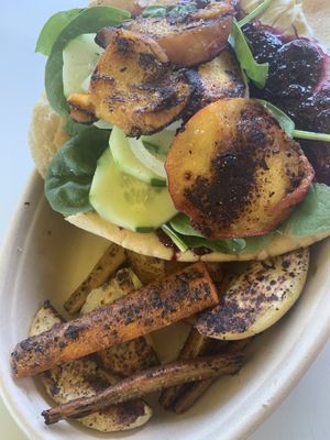 Blueberry jalapeño jam, seared peaches, “cream cheese” cucumbers and spinach on flatbread  at Veggie Thumper - Food Truck in Des Moines