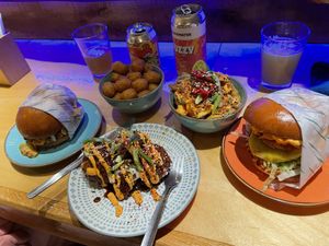 BBQ beef burger, kimchi chicken burger, Thai fries, tots, and cauliflower   at Wholesome Junkies in Manchester