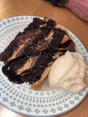 Salted caramel and chocolate cake with ice cream   at Wholesome Junkies in Manchester