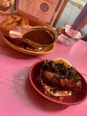 Pigs in blanket bao with with a yorkie pudding and gravy   at Wholesome Junkies in Manchester