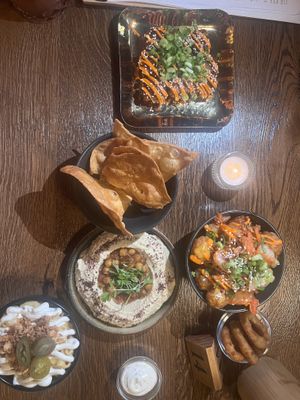 Tofu poppers, hummus and pita chips, Mac and cheese, onion rings, and kimchi tots   at Wholesome Junkies in Manchester