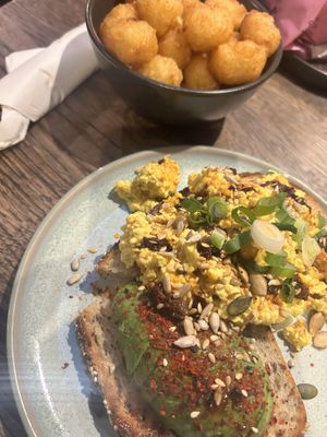 Tater tots, tofu scramble and avocado toast  at Wholesome Junkies in Manchester