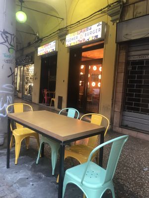 outside seating area and entrance  at Flower Burger in Bologna