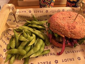Panino del mese: funghetto burger con burger di seitan, cavolo rosso marinato, rucola, smoky humus, funghi e salsa maio fungosa più edamame  at Flower Burger in Bologna