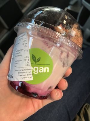 Vegan labeled soy yogurt, topped with fruit and granola at backWERK in Munich