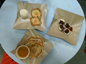 BBQ 'pork' bun, vegan eggs, roti Chennai and some white glutinous thing topped with fried onions that was delicious! at E-PACS Vegan Cafe in East Tamaki