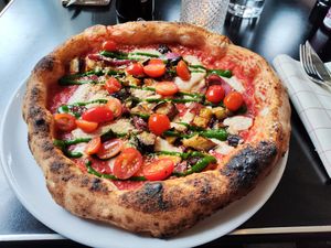 "Mozzarella", eggplant and date tomatoes pizza at Piu - Schiffbau in Zurich